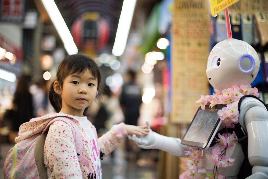 photo of girl laying left hand on white digital robot and testing machine learning