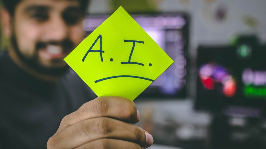 person holding green paper written artificial intelligence